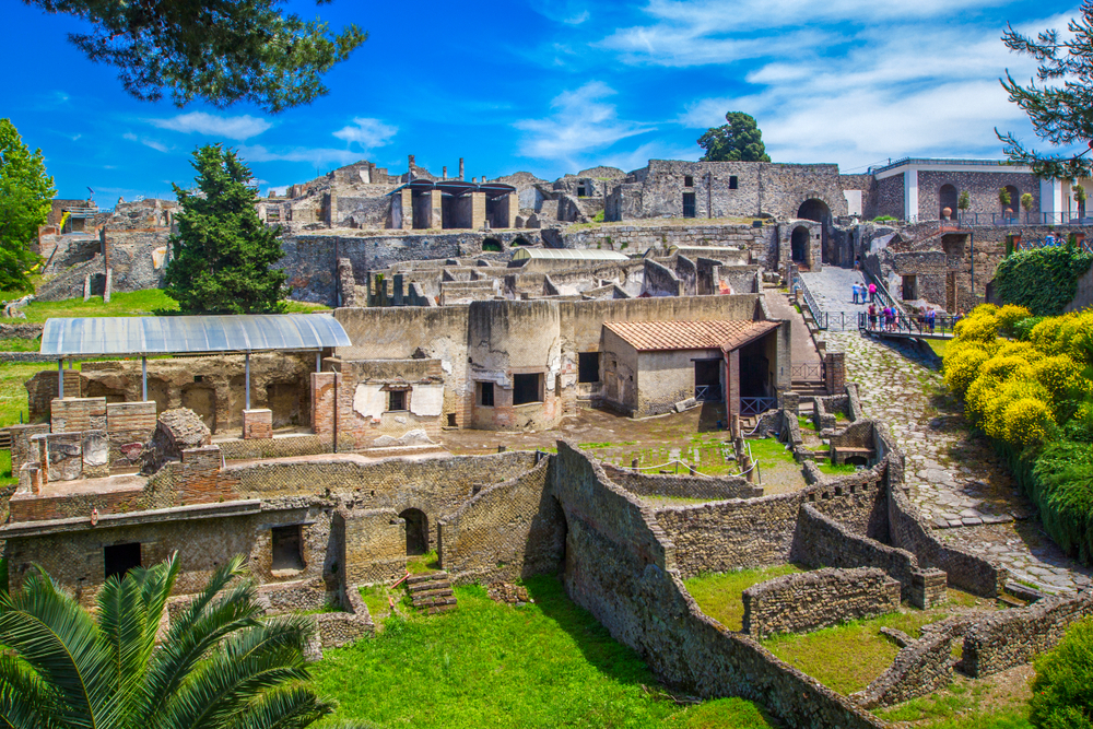 Panoramic view of the ancient ruins of Pompeii with Mount Vesuvius looming in the background