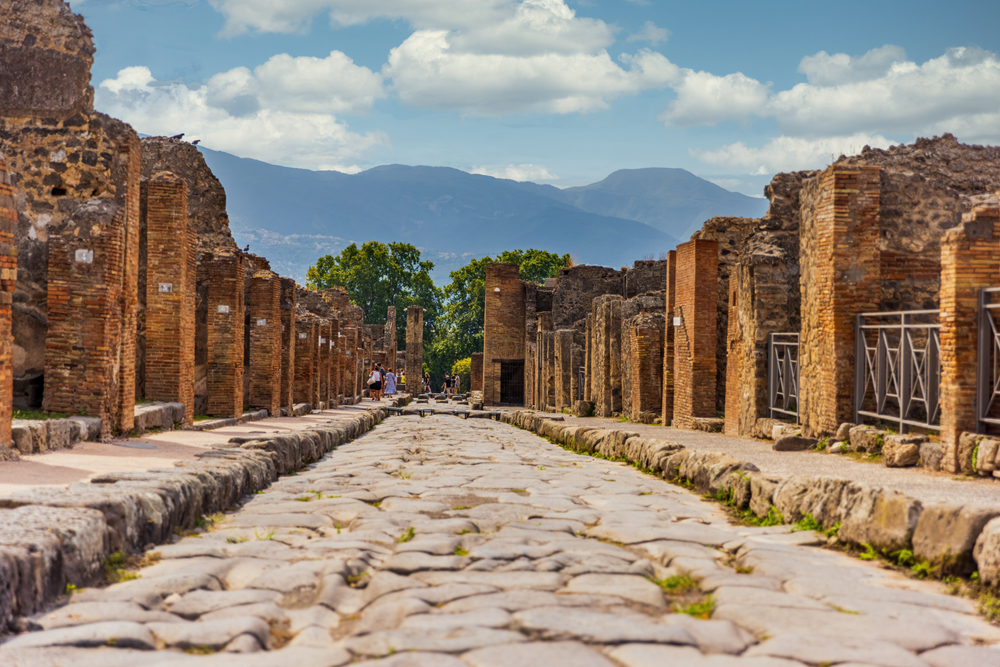 Temple ruins in Pompeii with standing columns and the sacred precinct